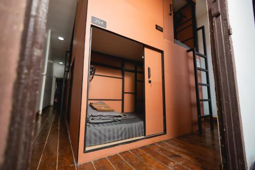 a mirror in a room with a bed in it at 1950 Luangprabang Hostel in Luang Prabang