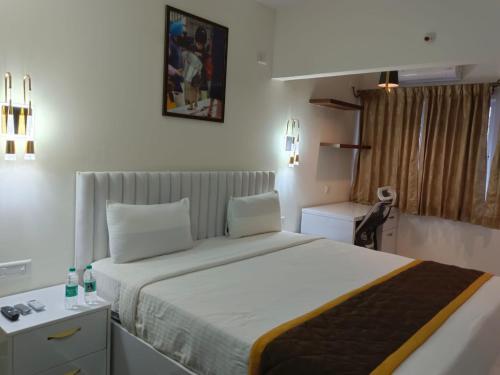 a bedroom with a large bed in a room at SS Lumina Guest House in Bengaluru