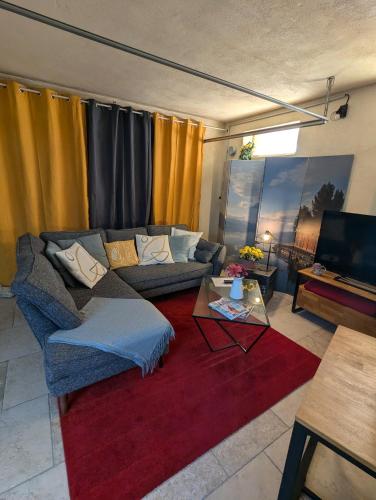 a living room with a couch and a table at Townhouse 3 bedrooms in Calvisson