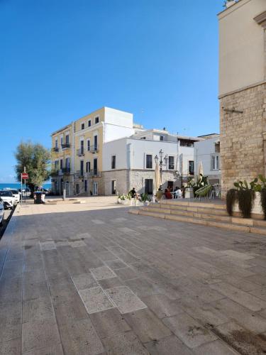 an empty street in a town with white buildings at Rossè B&B Holiday House in Trani