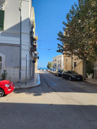 a street with cars parked on the side of a building at Rossè B&B Holiday House in Trani