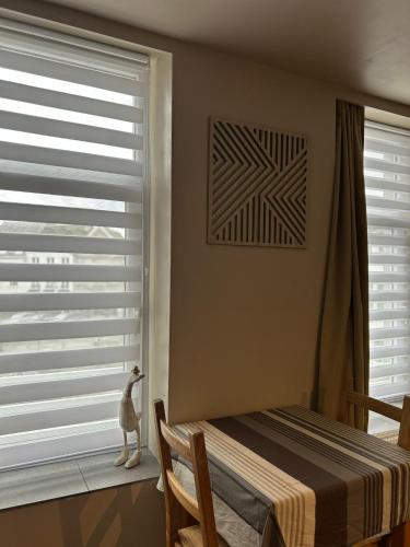 a bedroom with a window with blinds at Les petits nids de Nina 4 in Fosses-La-Ville