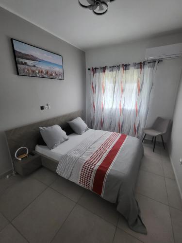 a bedroom with a large bed and a window at Abidjan in Cocody