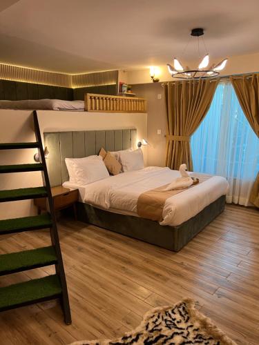 a bedroom with two bunk beds and a ladder at Ortus - Murree Hills in Murree