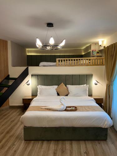 a bedroom with a large bed and a staircase at Ortus - Murree Hills in Murree