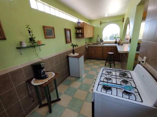 a kitchen with a stove and a counter top at Departamento de 1 a 3 huéspedes in Tonanzintla