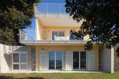 a house with a balcony on top of it at "Quercia House", inside a Private Park, shared Pool, Tennis, AC, Parking next home and a Garage in Lerici! in Lerici