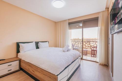 Postel nebo postele na pokoji v ubytování Migdal Gueliz Apart Hôtel