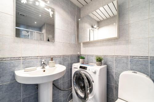 a bathroom with a washing machine and a sink at Top floor near ferry terminal - free parking in Tallinn