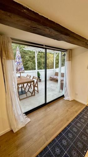 a room with a large sliding glass door with a table at La Majorelle du Palais des Papes in Avignon