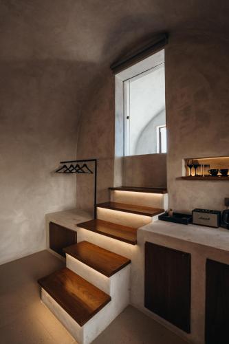 a staircase in a room with a window at Aethra Vegan Caves in Pirgos
