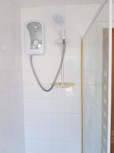 a shower in a bathroom with a shower head at 112 Sandown Holiday Park, Wifi, sleeps 4 in Sandown