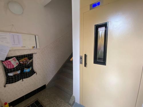 a hallway with a stairwell with a stair case with a door at Útulný byt v blízkosti centra in Juliánov