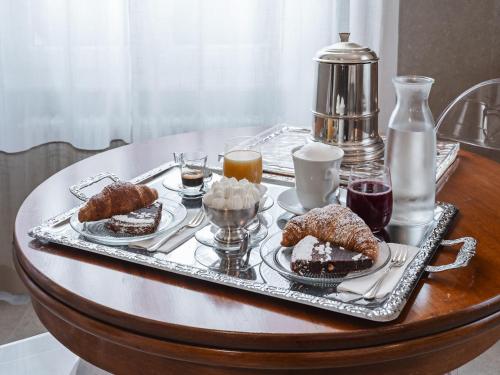 a tray of food on a table with desserts at Maison boutique Matteotti in Matera