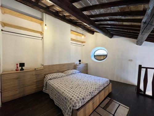 a bedroom with a bed and a window at Casa Matilde in Bassano in Teverina