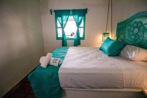 a bedroom with a large bed with a window at Hotel Costa 55 Puerto Escondido in Puerto Escondido