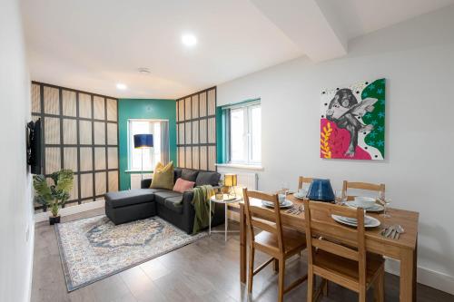 a living room with a couch and a table at Charming Chalk Farm Properties in London