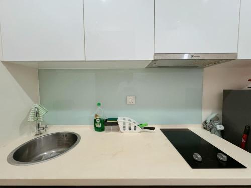 a kitchen with a sink and a counter top at Kuching Cozy Comfort 02 - Kozi Square Studio in Kuching