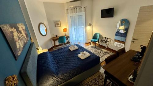 a bedroom with a blue bed and a living room at Trastevere Welcome Home Superior in Rome