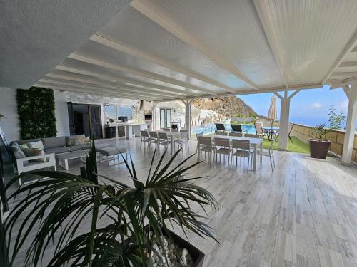 a patio with a white canopy and tables and chairs at Villa Los Zarzales in Güimar