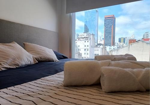 Postel nebo postele na pokoji v ubytování BORGES HOUSE APARTS Apartamentos con cochera a dos cuadras del Obelisco!