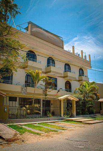 a large building with a fence in front of it at DEL VALLE HOUSE II in Ica
