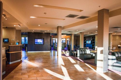 a lobby with couches and chairs in a building at Courtyard by Marriott Norman in Norman