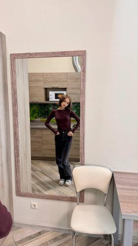 a woman standing in front of a mirror at Summit Apart Hotel in Kyiv