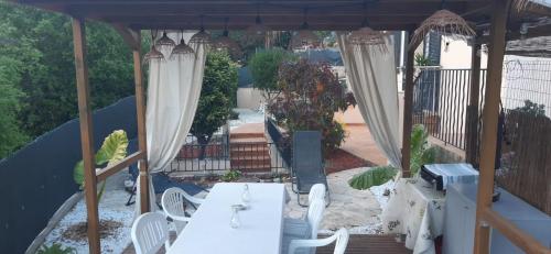un patio avec une table et des chaises sous un parasol dans l'établissement Chambre d'hôtes, à Menton