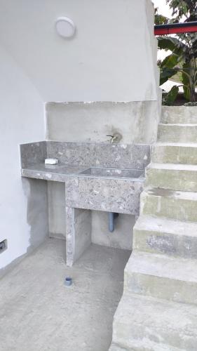 a stone bench sitting next to a set of stairs at Cabaña Monte Santo in Oxapampa