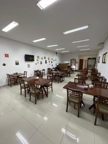a dining room with wooden tables and chairs at Hotel Estrela da Agua Fria in Sao Paulo