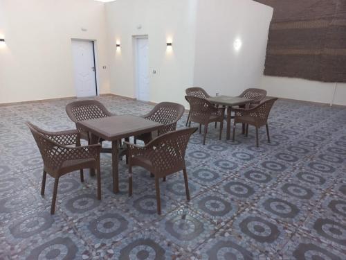 a group of tables and chairs in a room at Malak Guest House in Cairo