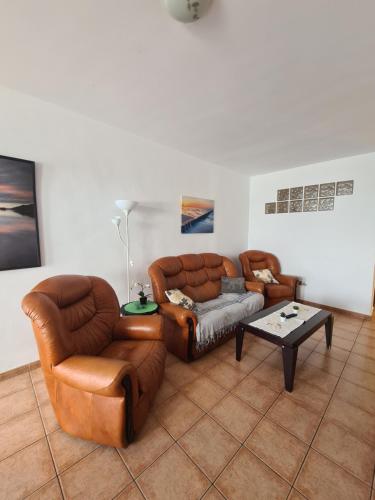 a living room with two couches and a coffee table at Famara Vela in Famara