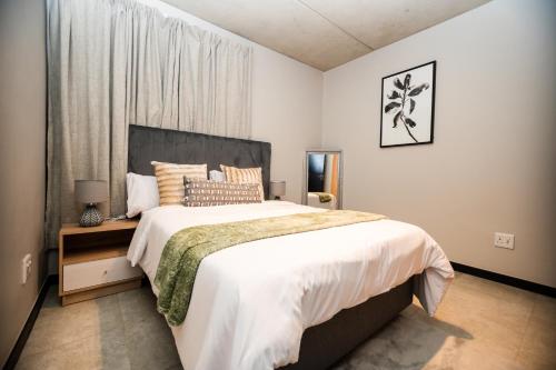 a bedroom with a large bed and a window at K47 propertyzz in Midrand