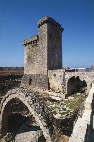an old building with a bridge and a tower at Casa Duca in Acquarica del Capo