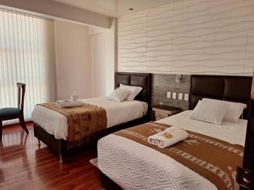 a hotel room with two beds and a chair at Hotel Salty House in Uyuni