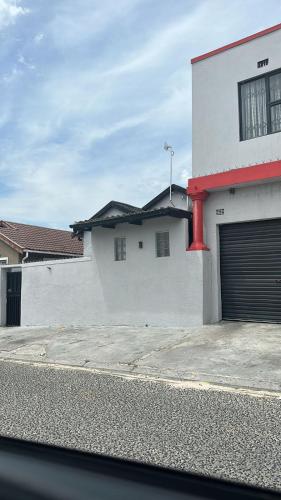 a white building with a garage door on the side of it at ILITHA PARK in Cape Town