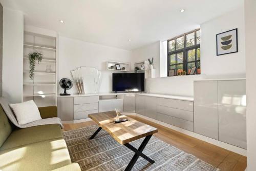 a living room with a couch and a coffee table at Lux Barn Conversion in Frodsham in Frodsham