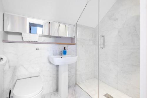 a bathroom with a toilet and a sink and a shower at Lux Barn Conversion in Frodsham in Frodsham