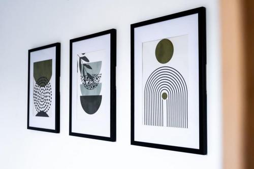 four framed pictures on a wall in a room at Lux Barn Conversion in Frodsham in Frodsham