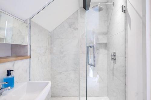 a bathroom with a shower and a sink at Lux Barn Conversion in Frodsham in Frodsham