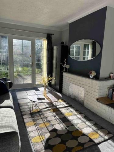a living room with a fireplace and a mirror at Birmingham Bungalow Serviced Apartment NEC Airport Bullring in Birmingham