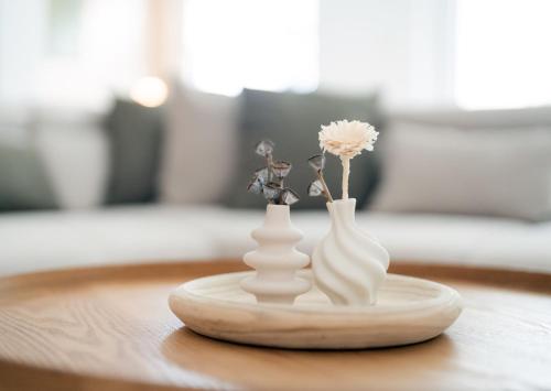 two white vases sitting on top of a table at LaMiaCasa Grande 140qm Family-Business Groups-Airport-Fair-Uni-Base in Stuttgart
