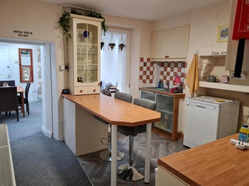 a kitchen with a wooden counter top in a room at Charming Lincoln Cottage Family & Pet-Friendly in Lincoln
