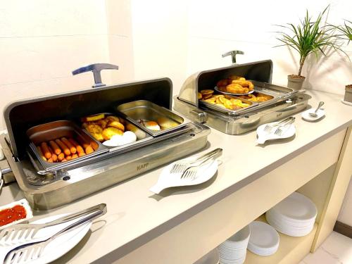 a buffet with some food on top of a counter at Apart Hotel Banovani in Tbilisi City
