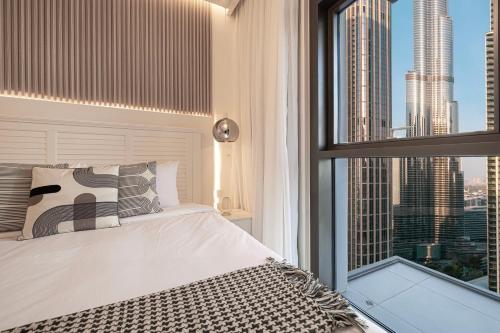 a bedroom with a bed and a large window at Lux Sky Residence, Burj Crown, Opera Boulevard View by Dubai Mall in Dubai