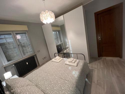 a bedroom with a bed and a chandelier at La casa di Jo in Navacchio