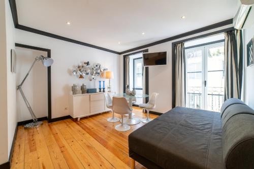 a bedroom with a bed and a table and chairs at Bliss Lisbon Apartments - Bairro Alto in Lisbon