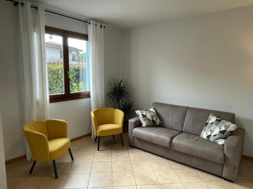 a living room with a couch and two chairs at Casa MontOrfano Erbusco in Erbusco