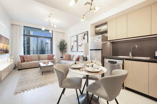 a kitchen and living room with a table and chairs at Lux Sky Residence, Burj Crown, Opera Boulevard View by Dubai Mall in Dubai